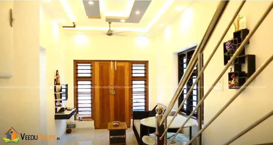 Living room with false ceiling and steel staircase railing