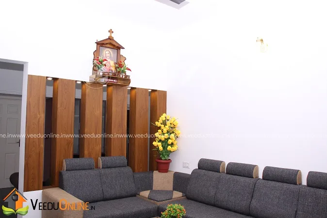 Living room with grey sofa, wooden partition and prayer niche