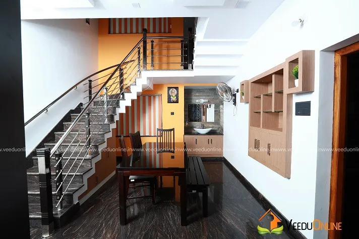 Staircase with steel railing and wooden display shelf