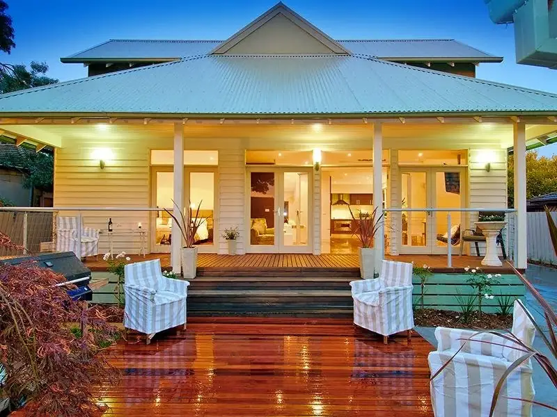 Single storey house with wooden deck verandah and lights