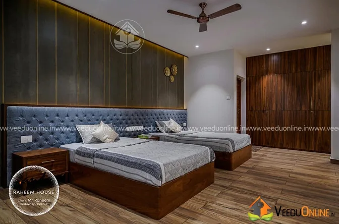 Bedroom with tufted blue headboard and twin beds