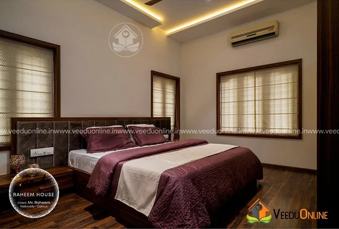 Bedroom with maroon bed linen and cove lighting