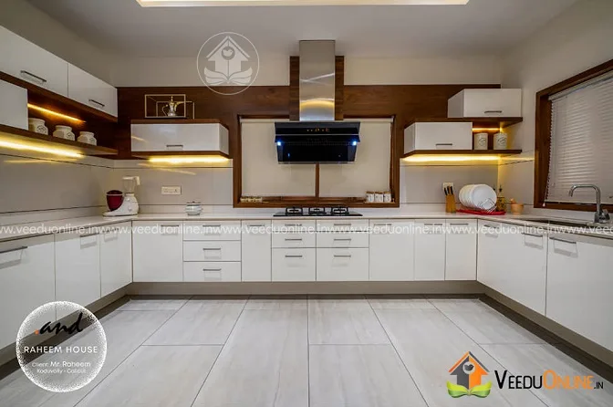 White modular kitchen with chimney in renovated home