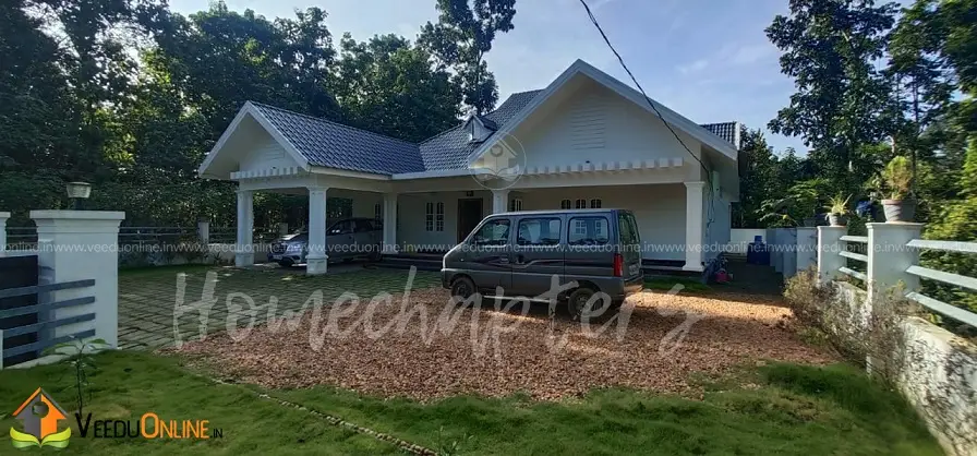 Completed Kerala house with lawn and sloping roof