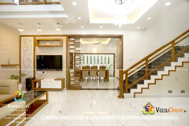 Living room with TV wall and wooden staircase