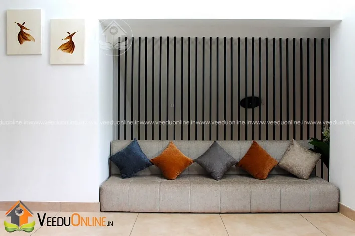 Window seat with cushions and wooden slat wall