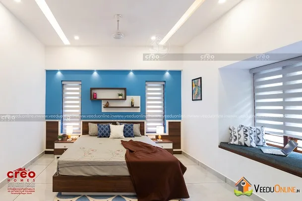 Bedroom with window seat and blue bedding