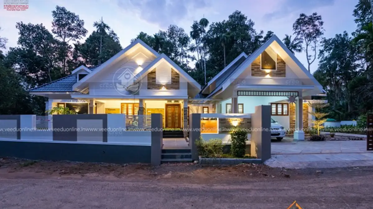 Large single floor house Kerala 2938 sq ft with sloping roofs at dusk