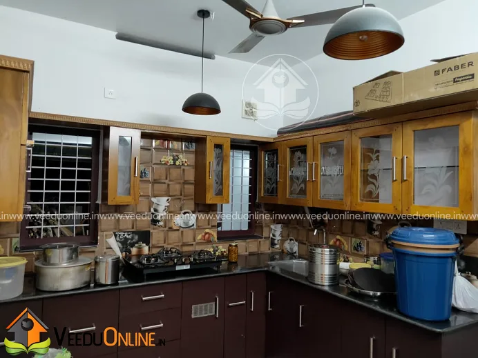 Kitchen with wooden cabinets and pendant lights