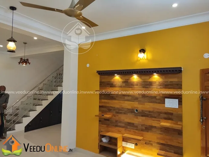 Staircase area with yellow wall and wooden panel shelf
