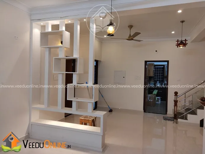 White partition shelf near staircase in living area