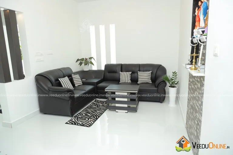 Living room with black leather sofa and white floor