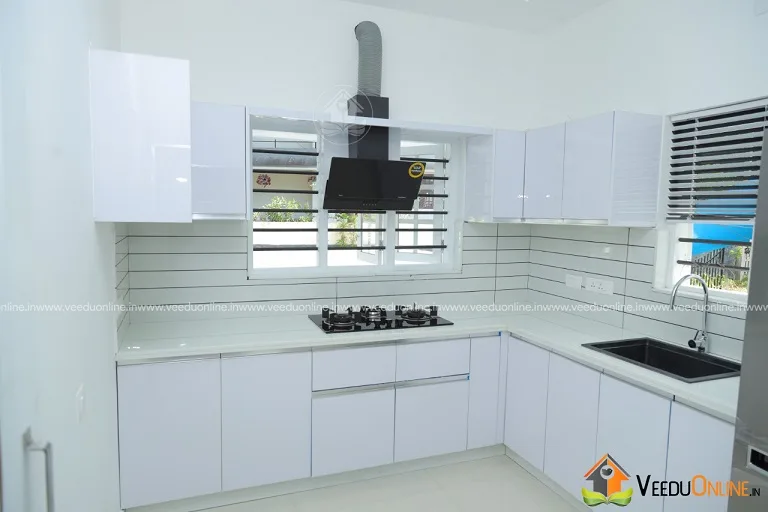 Kitchen with white cabinets and tiled backsplash